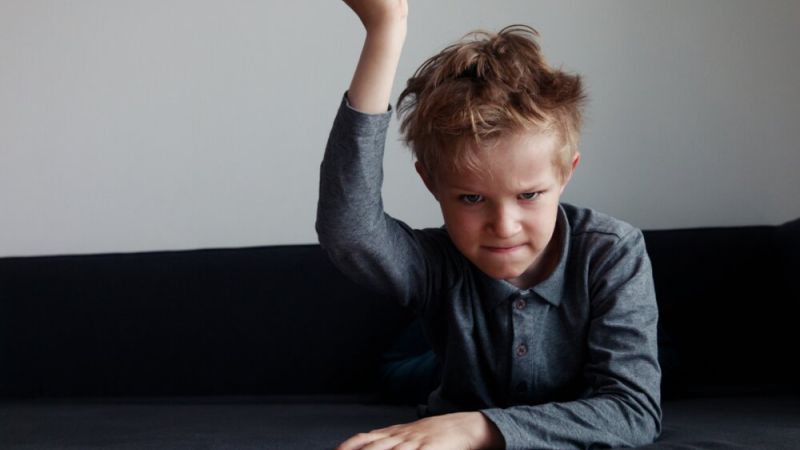 Angry child slamming table
