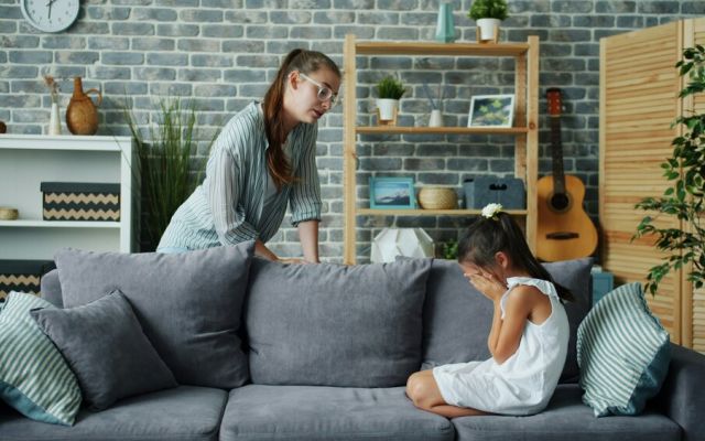 Child crying on sofa