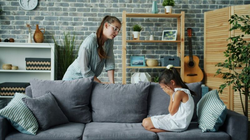 Child crying on sofa